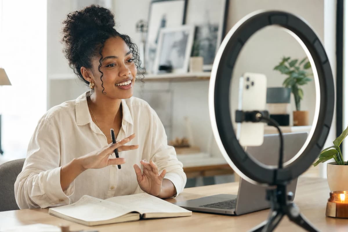 A woman reads through her notes at her desk before recording anything.